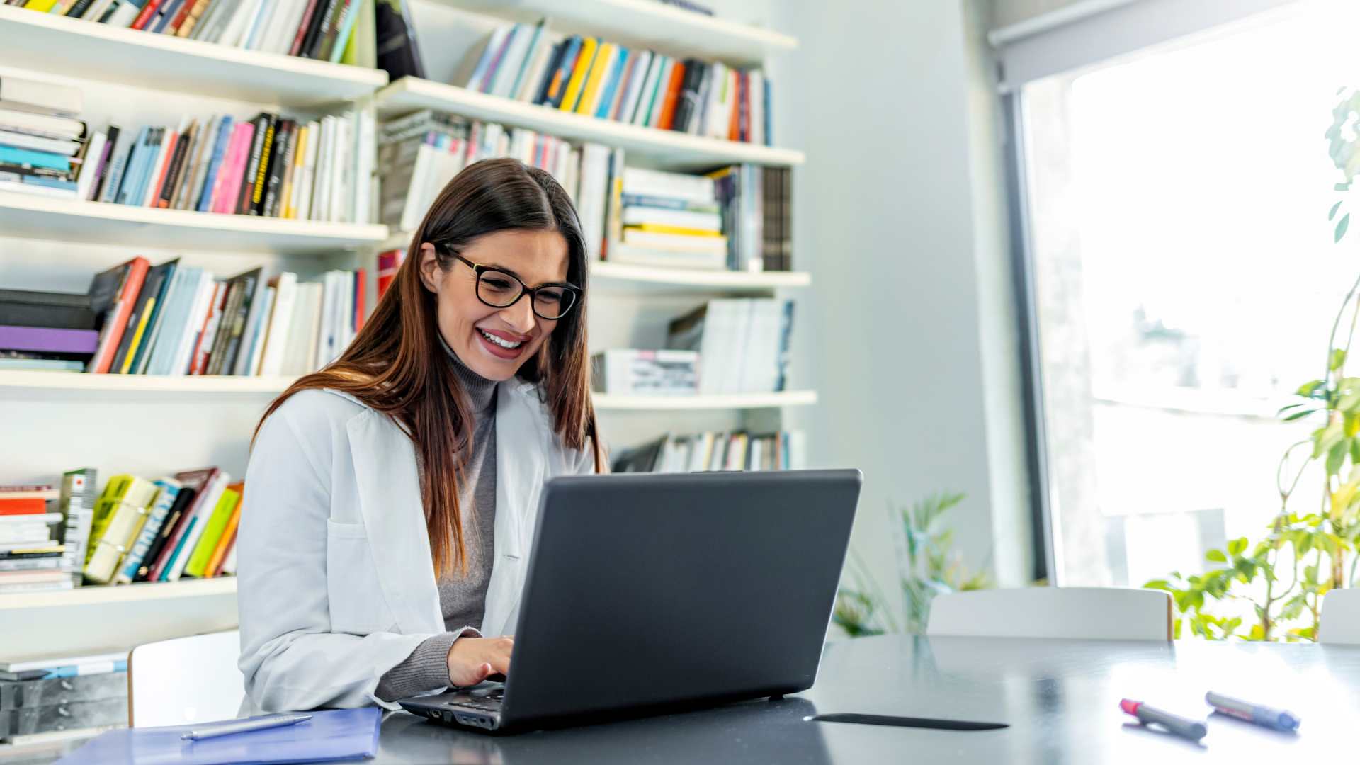 Healthcare student working on evidence-based practice proposal capstone project
